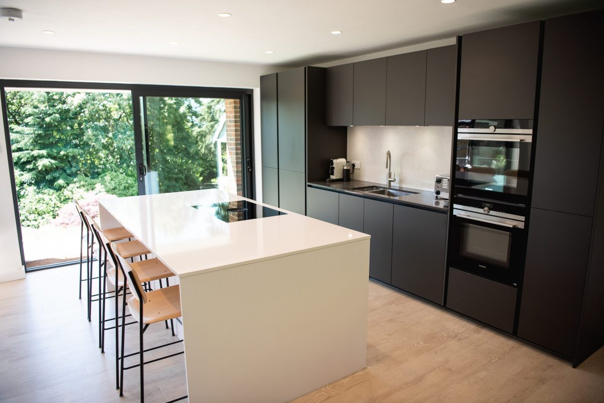 Grey and white handleless kitchen extension with island