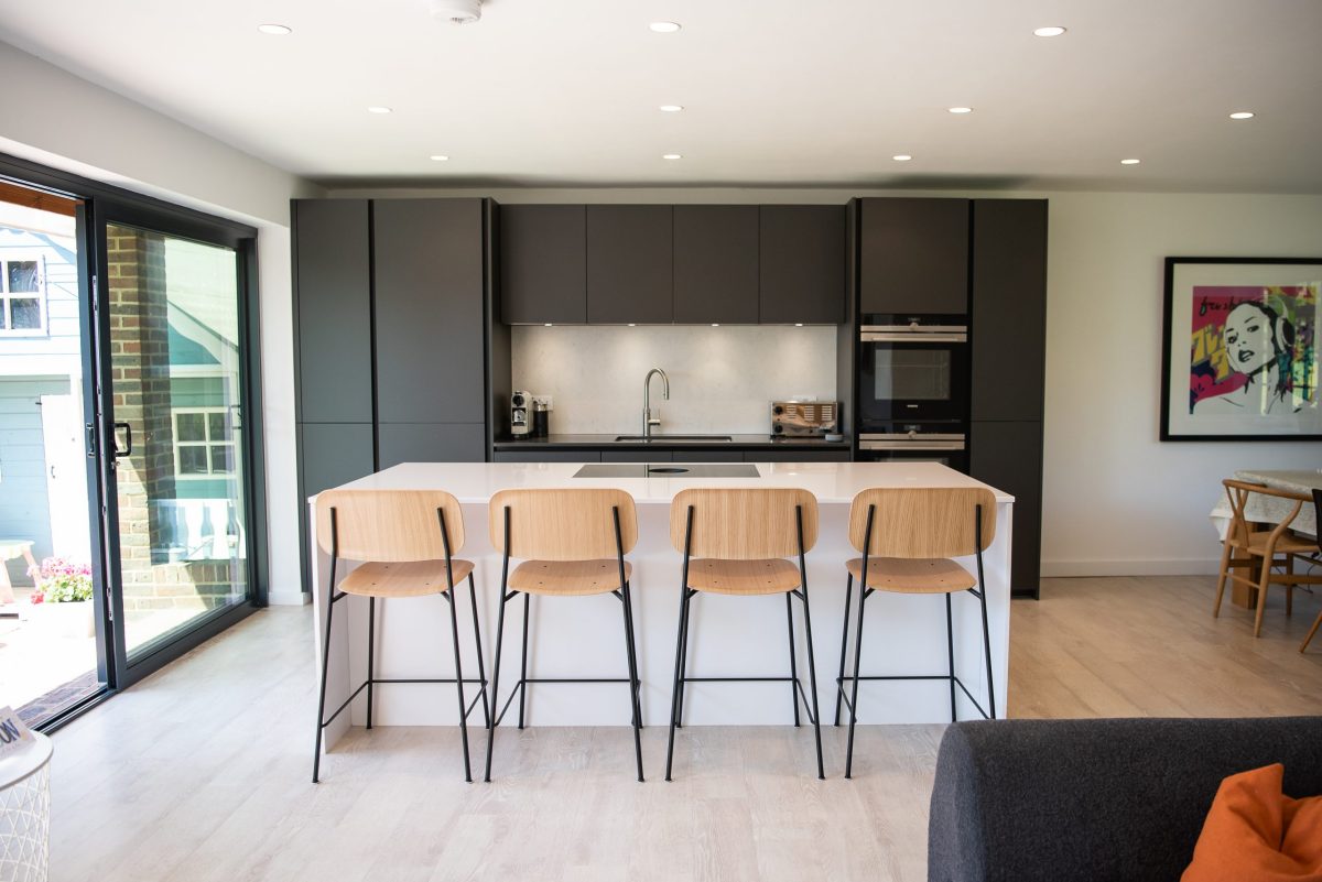 Grey and white handleless kitchen extension with island